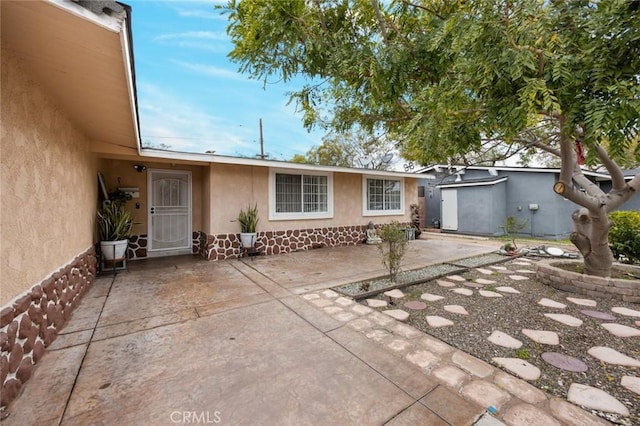 view of front of property featuring stucco siding and a patio area