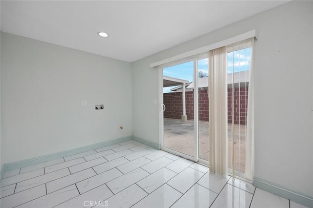 spare room featuring baseboards