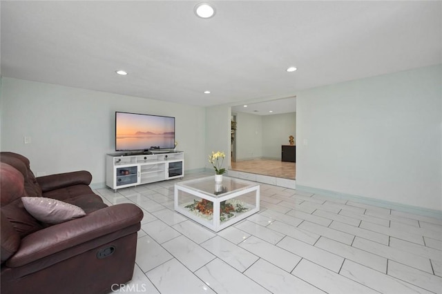 living room featuring recessed lighting, marble finish floor, and baseboards