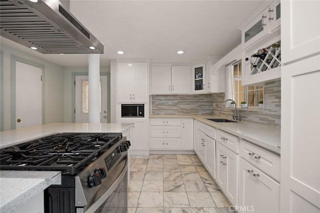 kitchen featuring marble finish floor, a sink, exhaust hood, black microwave, and stainless steel range with gas stovetop