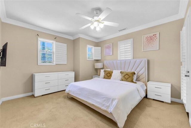 bedroom featuring visible vents, light carpet, baseboards, and ornamental molding