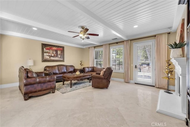 living room with beamed ceiling, ceiling fan, a fireplace, and baseboards