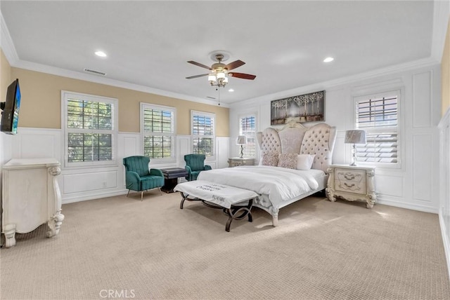 bedroom featuring multiple windows, carpet, and ornamental molding