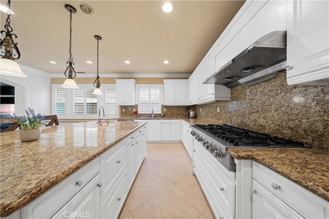 37 Shepard, Irvine, CA 92620 - kitchen with a sink, stainless steel gas stovetop, decorative backsplash, white cabinetry, and under cabinet range hood