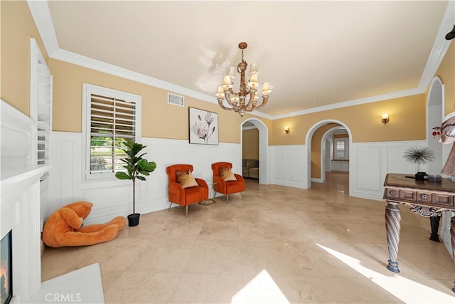 37 Shepard, Irvine, CA 92620 - sitting room featuring a decorative wall, arched walkways, an inviting chandelier, a wainscoted wall, and visible vents