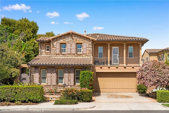 37 Shepard, Irvine, CA 92620 - view of front facade featuring stone siding, a tiled roof, driveway, and a garage