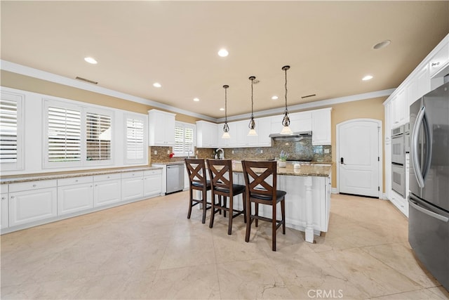 37 Shepard, Irvine, CA 92620 - kitchen with a breakfast bar, ornamental molding, stainless steel appliances, and white cabinets