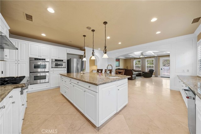 37 Shepard, Irvine, CA 92620 - kitchen featuring a sink, ceiling fan, arched walkways, appliances with stainless steel finishes, and visible vents