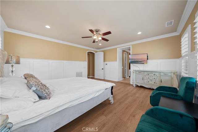 37 Shepard, Irvine, CA 92620 - bedroom with light wood-style flooring, wainscoting, visible vents, crown molding, and a decorative wall