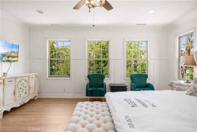 37 Shepard, Irvine, CA 92620 - bedroom featuring a decorative wall, light wood-style flooring, a wainscoted wall, multiple windows, and crown molding