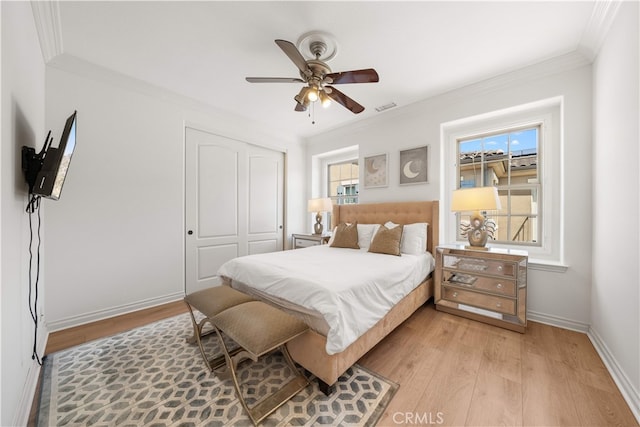 37 Shepard, Irvine, CA 92620 - bedroom featuring multiple windows, a closet, ornamental molding, light wood finished floors, and a ceiling fan