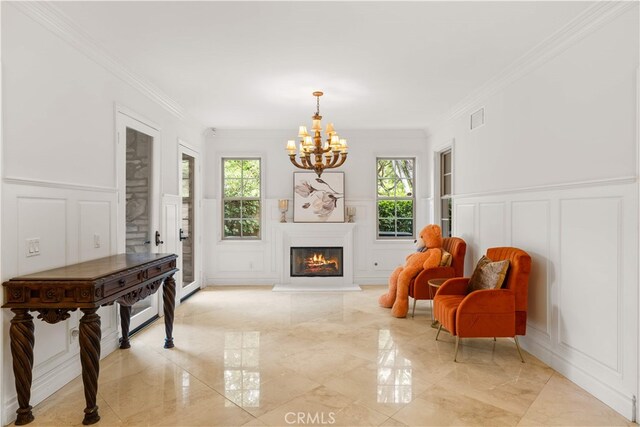 37 Shepard, Irvine, CA 92620 - living area featuring a decorative wall, a chandelier, crown molding, a glass covered fireplace, and wainscoting