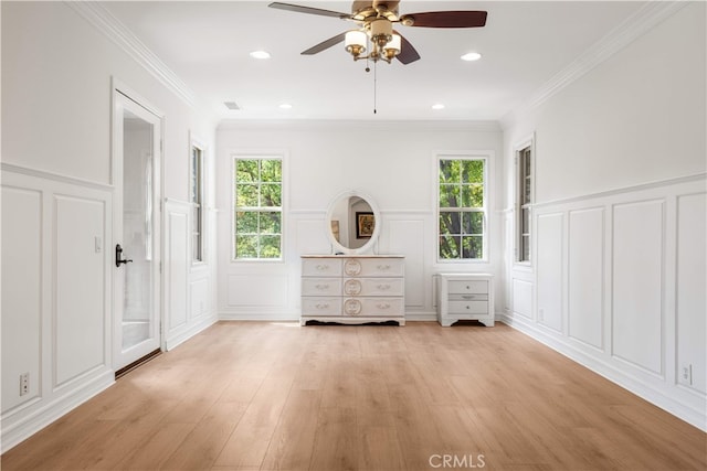 37 Shepard, Irvine, CA 92620 - bedroom featuring a decorative wall, multiple windows, light wood finished floors, a wainscoted wall, and crown molding