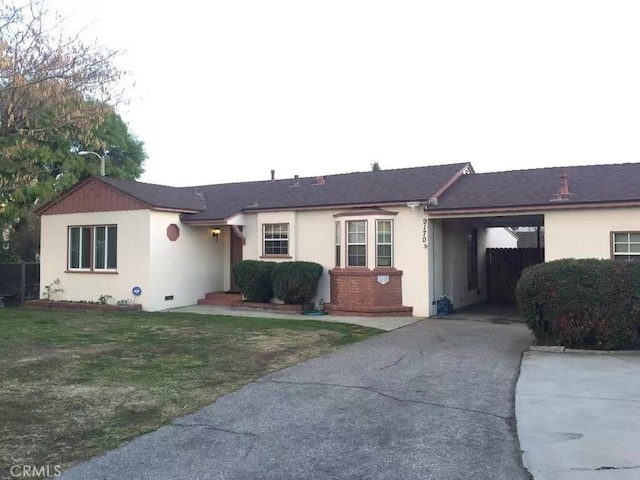 single story home with driveway, stucco siding, a front lawn, and brick siding