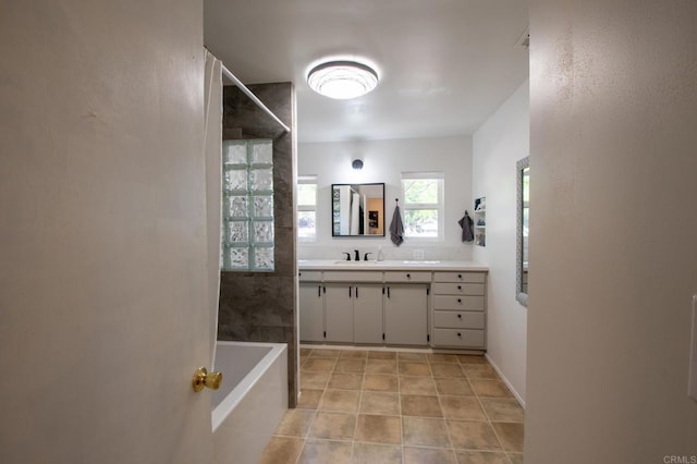 bathroom featuring tile patterned floors, walk in shower, vanity, and a bath