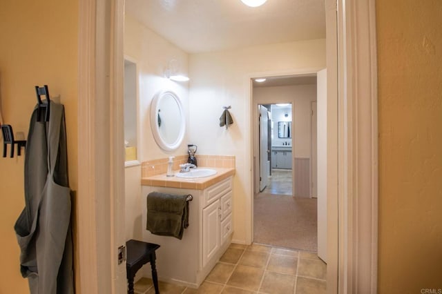 bathroom featuring tile patterned flooring and vanity