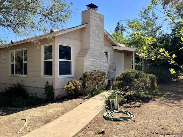 view of side of property featuring a chimney