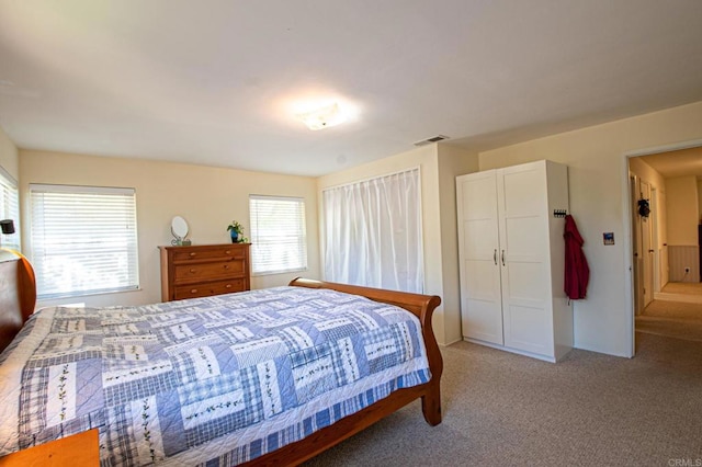 bedroom with light carpet and visible vents