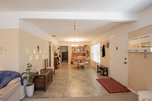 interior space with a chandelier, light tile patterned flooring, visible vents, baseboards, and beamed ceiling