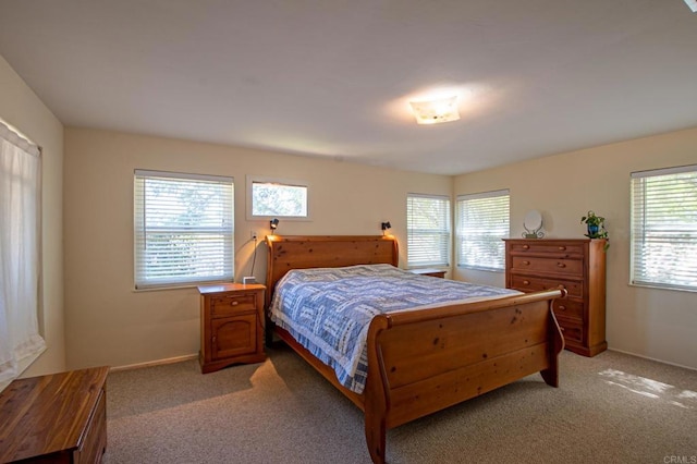 bedroom with light carpet and baseboards