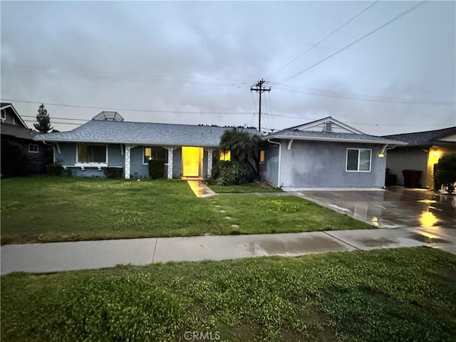 single story home featuring driveway and a front lawn