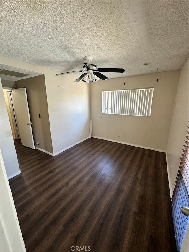 unfurnished room featuring a ceiling fan, a textured ceiling, baseboards, and wood finished floors