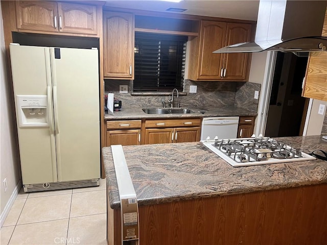 kitchen featuring light tile patterned floors, extractor fan, white appliances, a sink, and tasteful backsplash