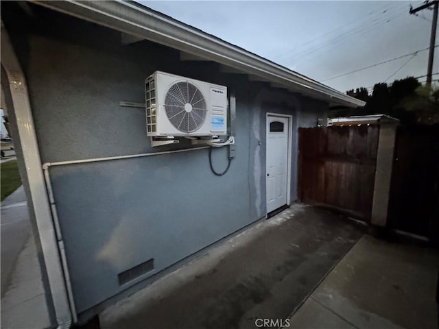 exterior space featuring ac unit and fence