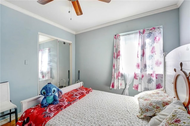 bedroom with crown molding, wood finished floors, and ceiling fan