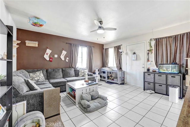 living area featuring light tile patterned floors and a ceiling fan