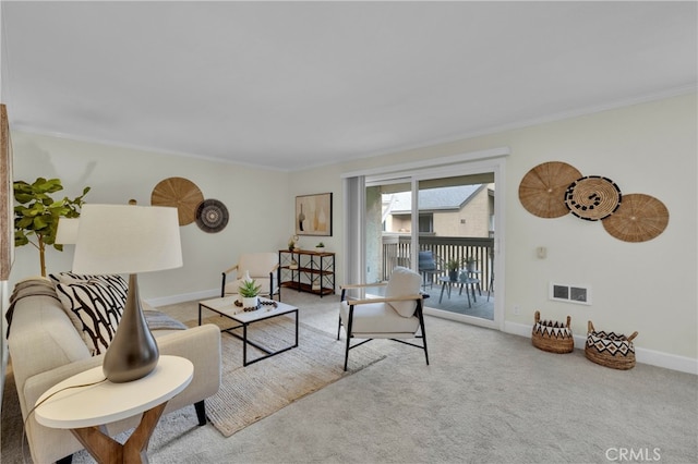 carpeted living area featuring ornamental molding, visible vents, and baseboards