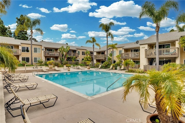 community pool featuring a residential view and a patio area