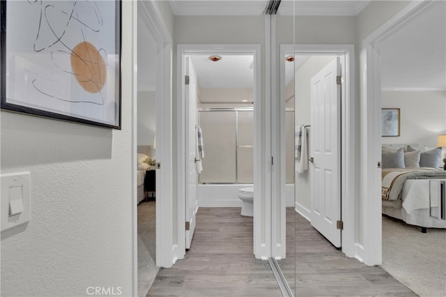 hall featuring crown molding and wood finished floors