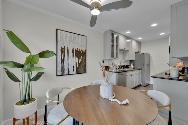 dining space with a ceiling fan, baseboards, crown molding, and recessed lighting