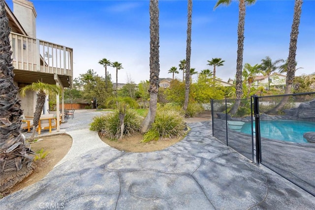 view of patio with fence and a fenced in pool