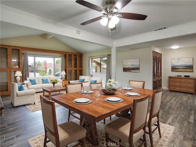 dining room with a healthy amount of sunlight, visible vents, dark wood finished floors, and lofted ceiling with beams