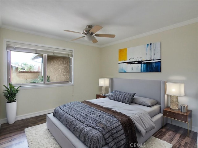 bedroom featuring ceiling fan, crown molding, baseboards, and wood finished floors