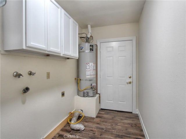 clothes washing area featuring cabinet space, baseboards, dark wood-style floors, water heater, and electric dryer hookup