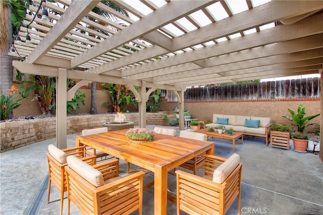 view of patio / terrace with outdoor dining space, an outdoor living space with a fire pit, and fence