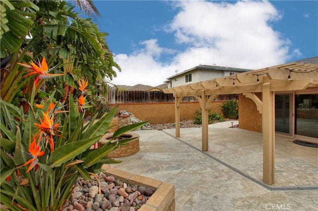 view of patio / terrace featuring fence and a pergola