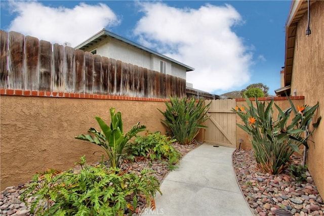 view of yard with fence and a gate