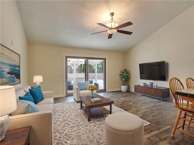 living area featuring lofted ceiling, ceiling fan, wood finished floors, and baseboards