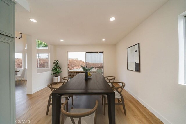 dining area with light wood finished floors, baseboards, and recessed lighting