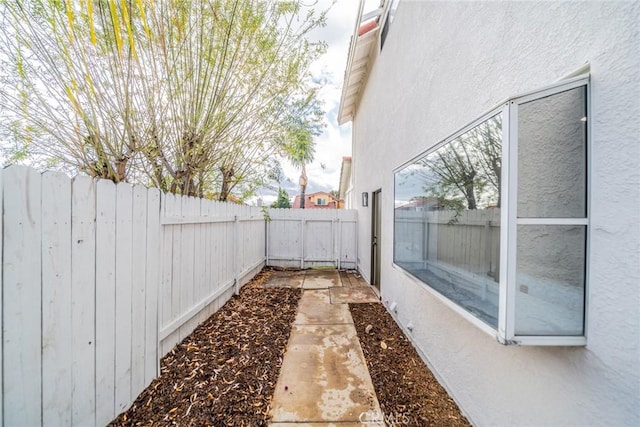 view of yard featuring a fenced backyard and a gate