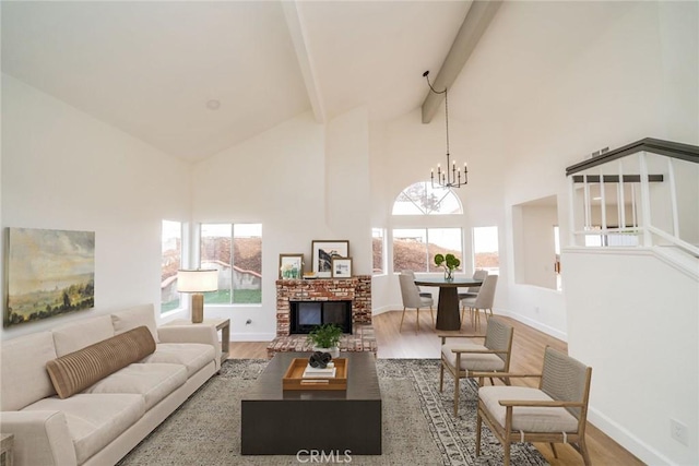 living area featuring an inviting chandelier, wood finished floors, high vaulted ceiling, beamed ceiling, and baseboards