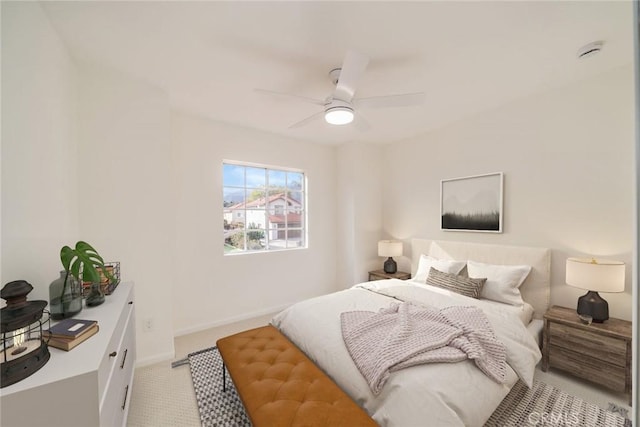 bedroom featuring light carpet, ceiling fan, and baseboards