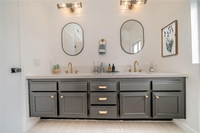 bathroom featuring a sink and double vanity