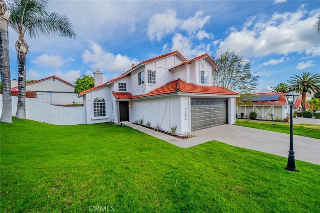 mediterranean / spanish-style house with a garage, a tile roof, fence, concrete driveway, and a front lawn