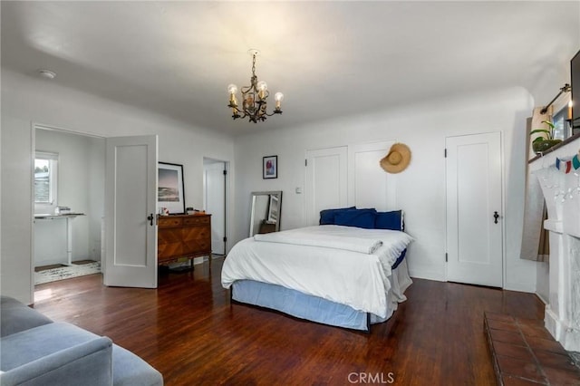 bedroom featuring wood finished floors and an inviting chandelier