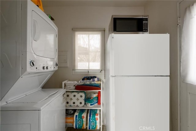 laundry room with laundry area and stacked washer / dryer